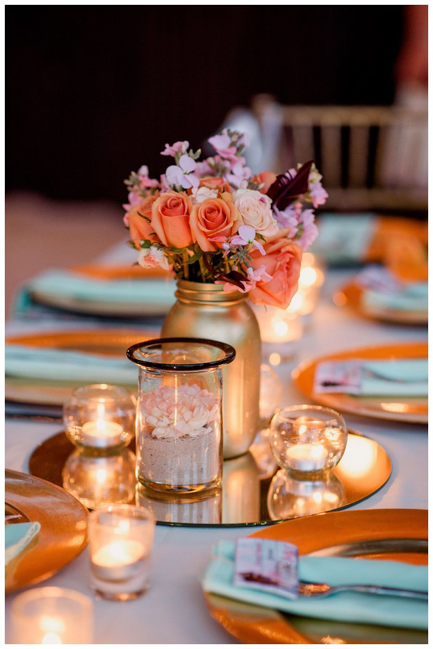 mirror centerpiece decorated with bouquete of roses and candles