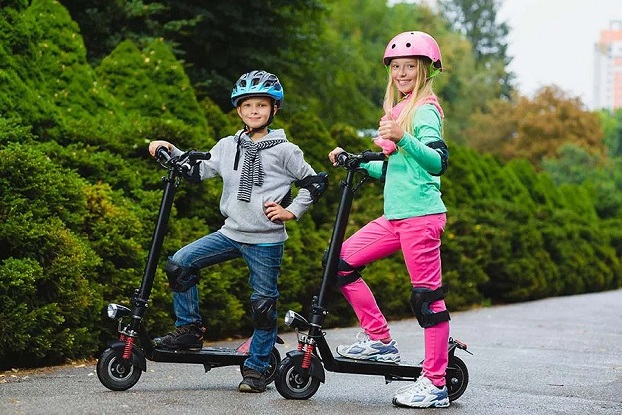 kids on scooters with safety gear