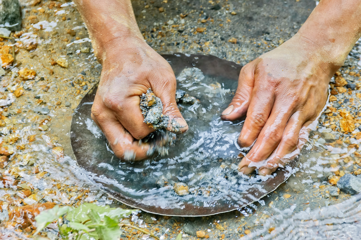 picture of closeup of hands gold panning in a river 