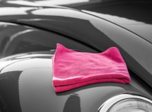 a pink car cleaning towel placed on a car