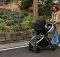 mother walking with her baby with travel stroller